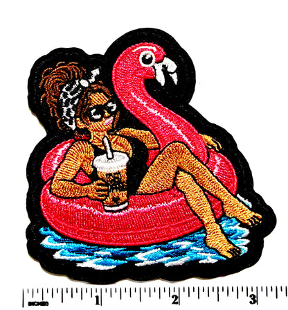 Girl with Messy Bun on a Flamingo Pool Float patch - Embroidered DIY Iron-On Applique 3”